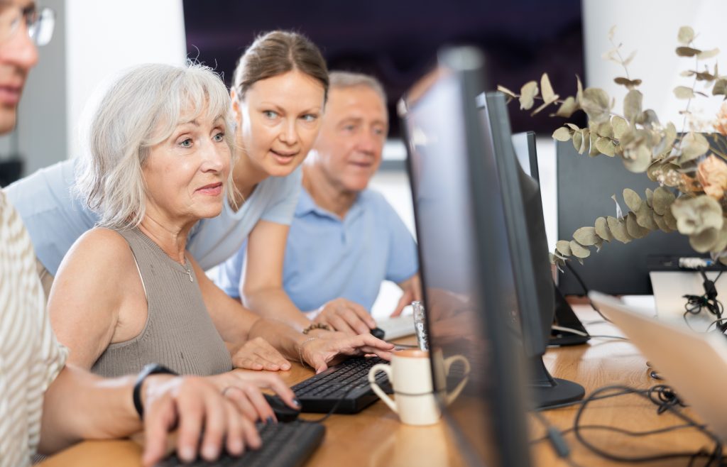 Adult,Woman,Teacher,Teaches,Group,Of,Elderly,People,To,Use